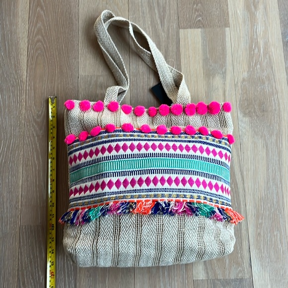 NWT. Pom Pom boho style tote. Lined w/ zip pocket & snap closure. Bright colors. - Picture 1 of 7